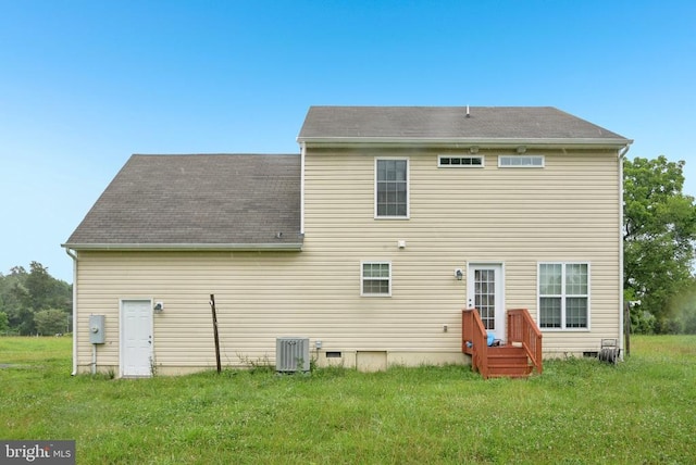  - back of house with a lawn and crawl space