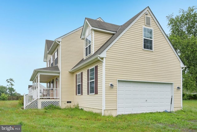  - view of side of home featuring a garage, a porch, and a yard