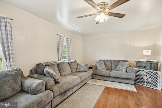  - living area with healthy amount of natural light, hardwood / wood-style floors, and a ceiling fan