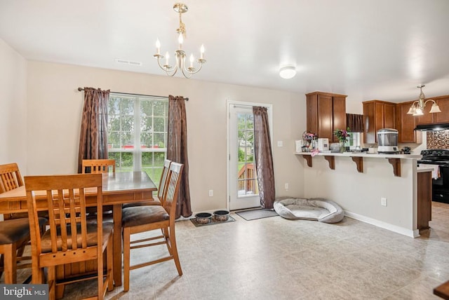  - dining space featuring a chandelier