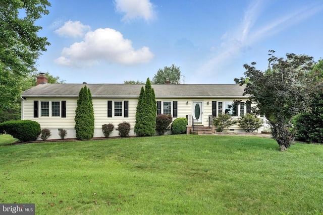 - single story home featuring a front lawn, a chimney, and crawl space