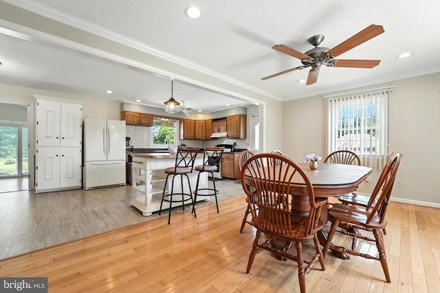  - dining space with light wood-style floors, a ceiling fan, recessed lighting, ornamental molding, and a textured ceiling