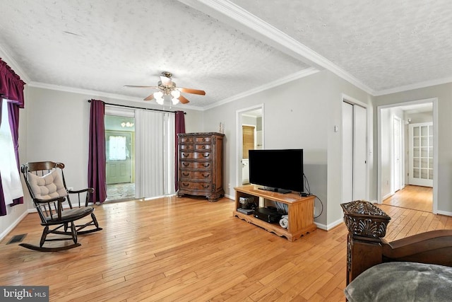  - living room with light wood-style floors, a textured ceiling, a ceiling fan, and ornamental molding