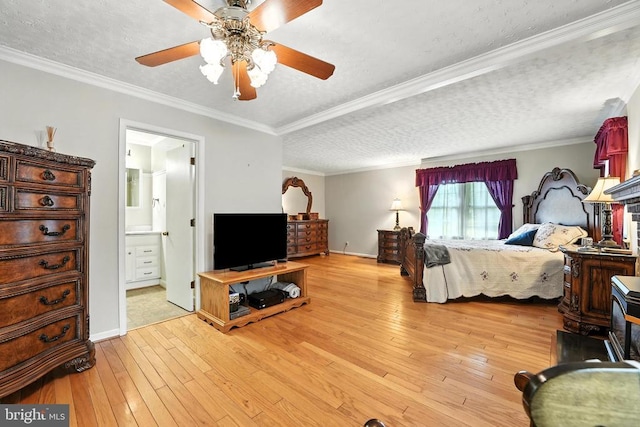  - bedroom featuring a textured ceiling, light wood finished floors, ornamental molding, connected bathroom, and ceiling fan