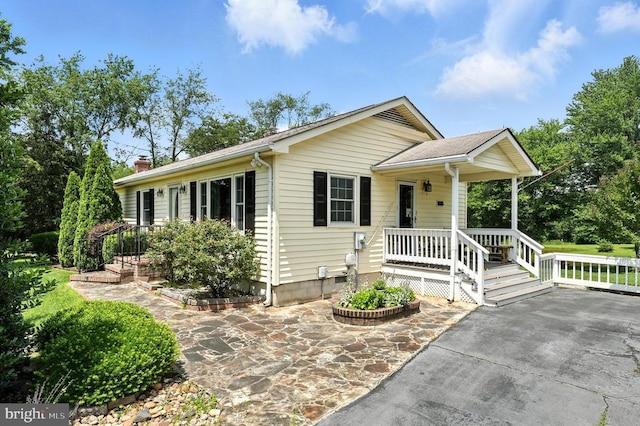  - ranch-style home featuring a chimney