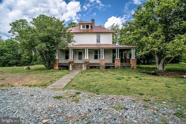 2315 Rolling Rd S, Scottsville, VA 24590 - view of front of home featuring a porch, a metal roof, a chimney, and a front lawn