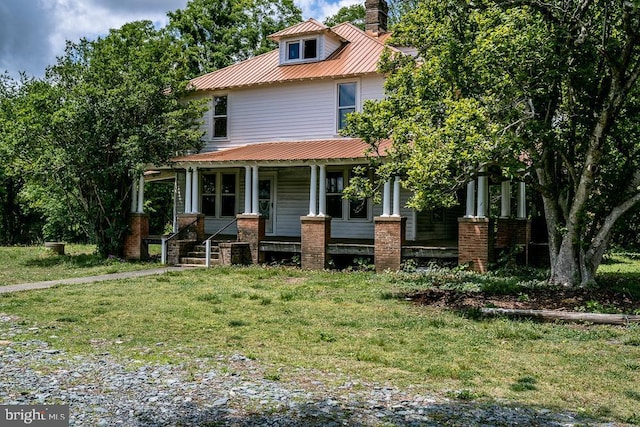 2315 Rolling Rd S, Scottsville, VA 24590 - traditional style home with a porch, a metal roof, a chimney, and a front lawn