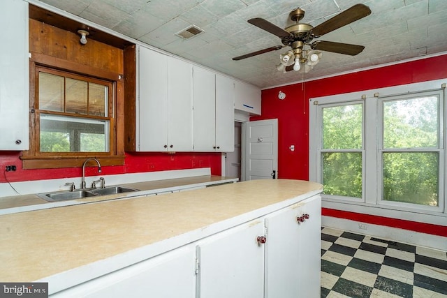 2315 Rolling Rd S, Scottsville, VA 24590 - kitchen featuring light floors, light countertops, white cabinetry, and a ceiling fan