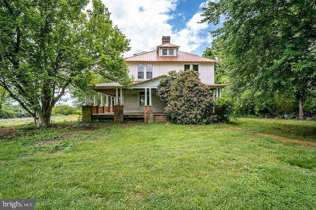 2315 Rolling Rd S, Scottsville, VA 24590 - back of house with a porch, a lawn, a chimney, and a metal roof