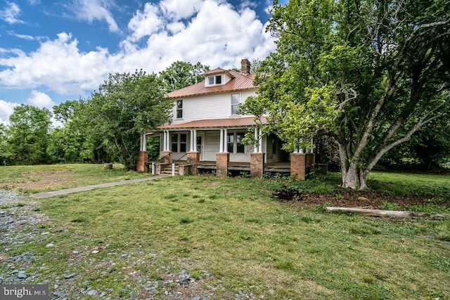 2315 Rolling Rd S, Scottsville, VA 24590 - traditional style home with a porch, a front yard, a metal roof, and a chimney