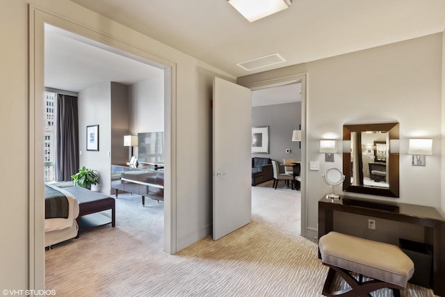 hallway with light colored carpet