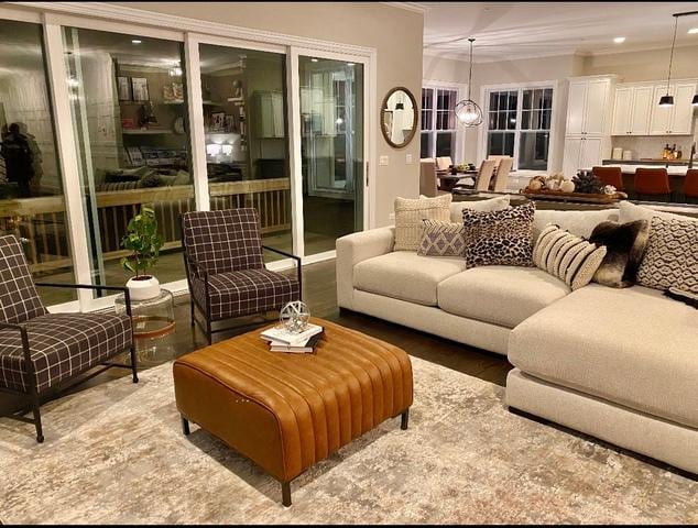 living room with ornamental molding and wood-type flooring