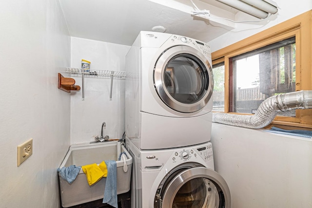 laundry room featuring stacked washer / drying machine