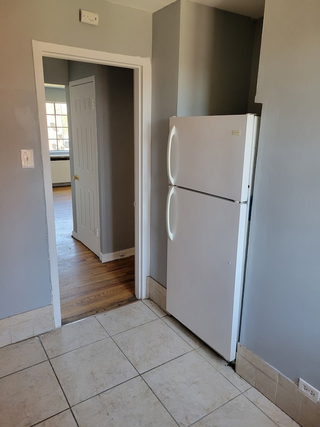 kitchen featuring light hardwood / wood-style floors and white fridge