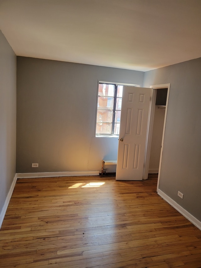 unfurnished room featuring dark wood-type flooring