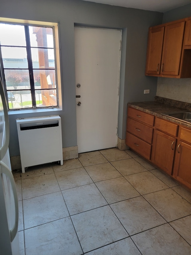 kitchen with sink and light tile floors