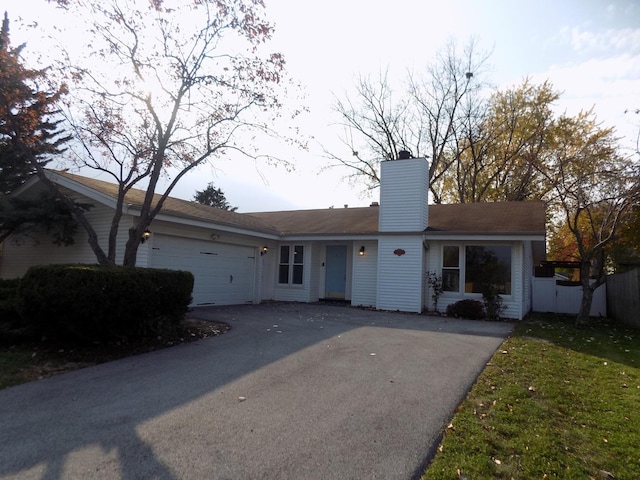 single story home with a front lawn and a garage