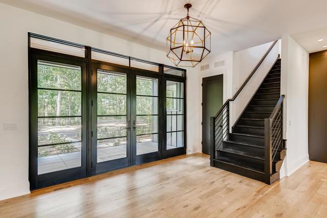 doorway to outside featuring a chandelier, french doors, and light wood-type flooring