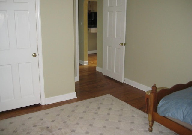 bedroom with hardwood / wood-style flooring