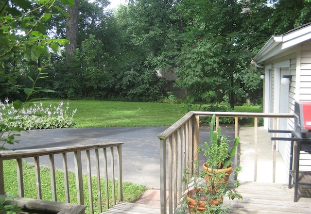 wooden deck featuring a yard