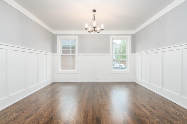 empty room featuring an inviting chandelier and dark wood-type flooring