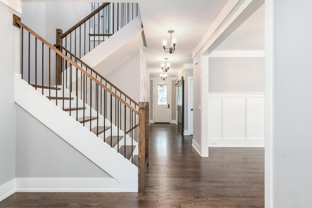 entrance foyer featuring a chandelier and dark wood-type flooring