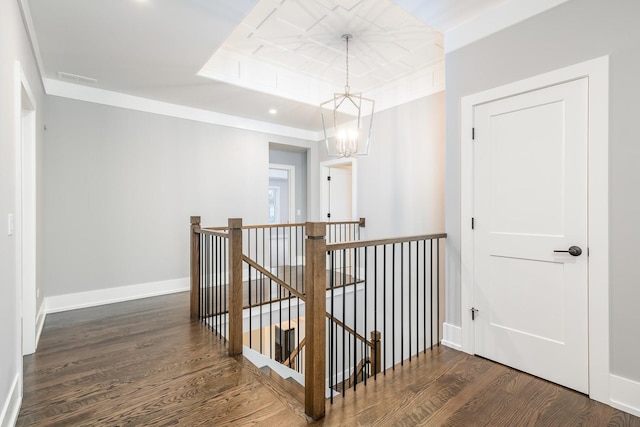 corridor featuring a chandelier and dark wood-type flooring