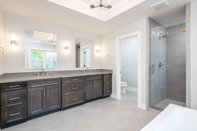 bathroom featuring toilet, large vanity, dual sinks, tile floors, and an enclosed shower