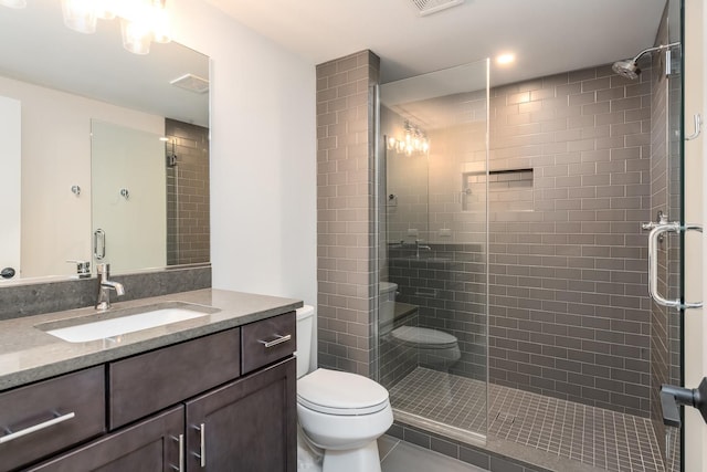 bathroom featuring an enclosed shower, toilet, vanity, and tile floors