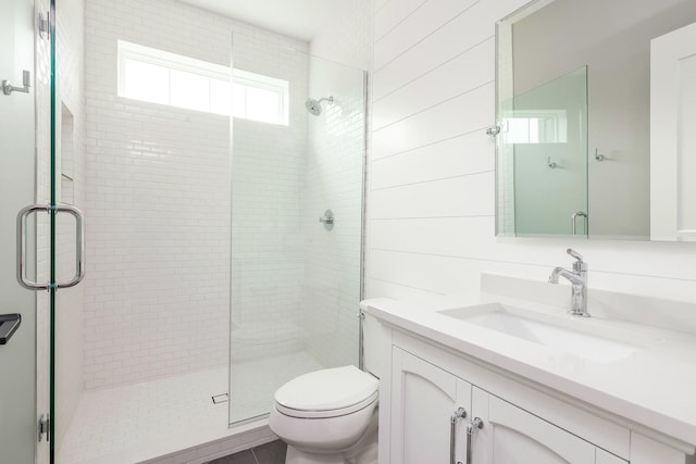 bathroom featuring an enclosed shower, oversized vanity, and toilet