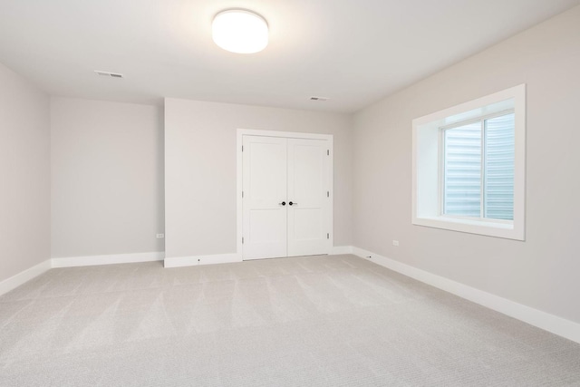 unfurnished room with light carpet