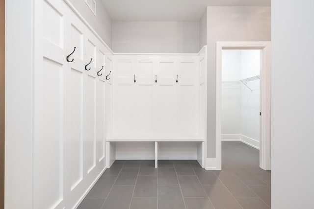 mudroom featuring dark tile flooring