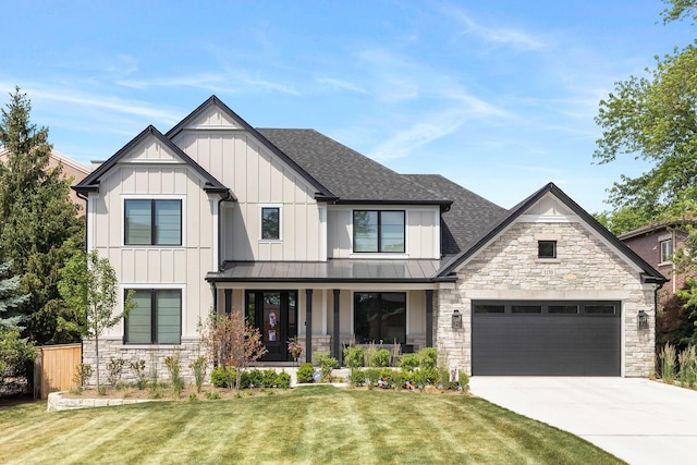 view of front of property with a front lawn and a garage