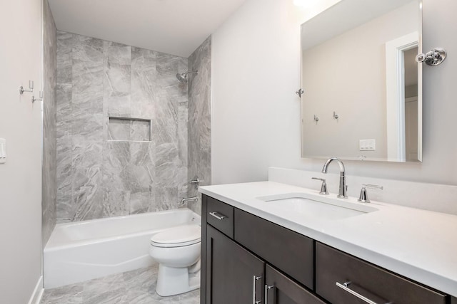 full bathroom with tiled shower / bath, toilet, vanity with extensive cabinet space, and tile flooring