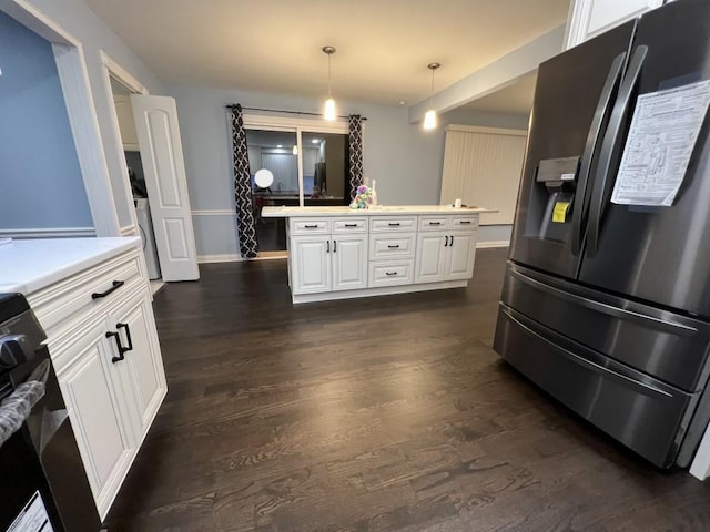 kitchen featuring electric range, dark hardwood / wood-style floors, stainless steel fridge, pendant lighting, and white cabinets