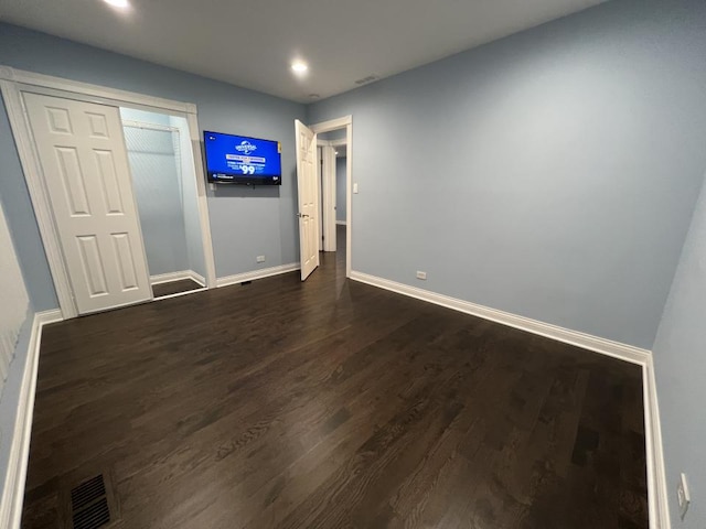 spare room featuring dark hardwood / wood-style flooring