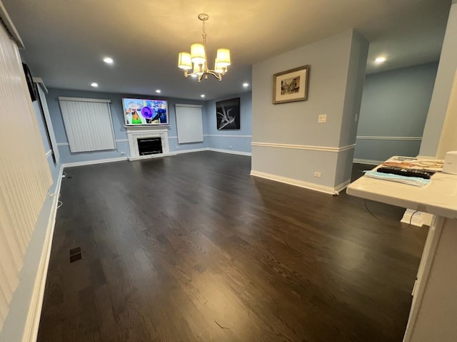 unfurnished living room featuring dark hardwood / wood-style flooring and a chandelier