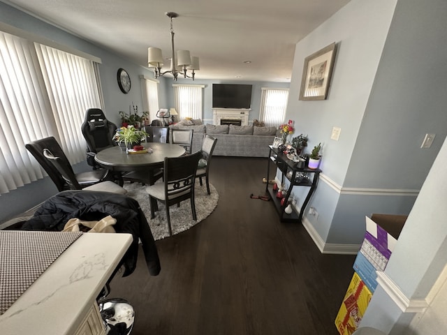 dining space with dark hardwood / wood-style floors and a notable chandelier