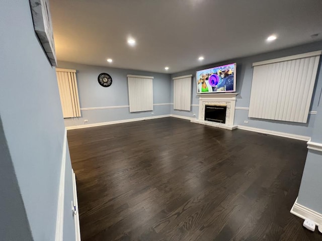 unfurnished living room with dark wood-type flooring