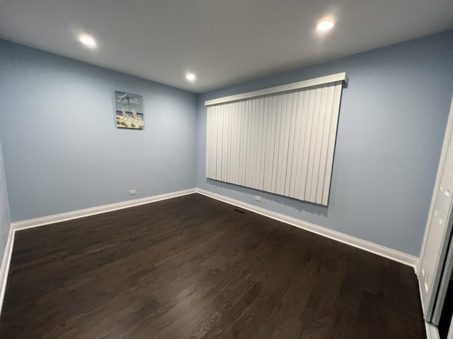 empty room featuring dark hardwood / wood-style flooring