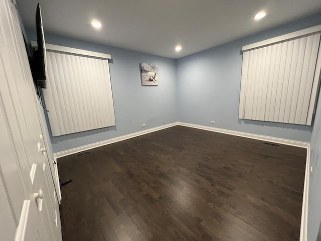 spare room with dark hardwood / wood-style floors