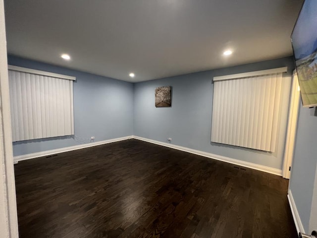 unfurnished room with dark hardwood / wood-style flooring