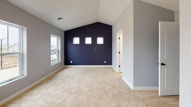 entrance foyer with light carpet and vaulted ceiling