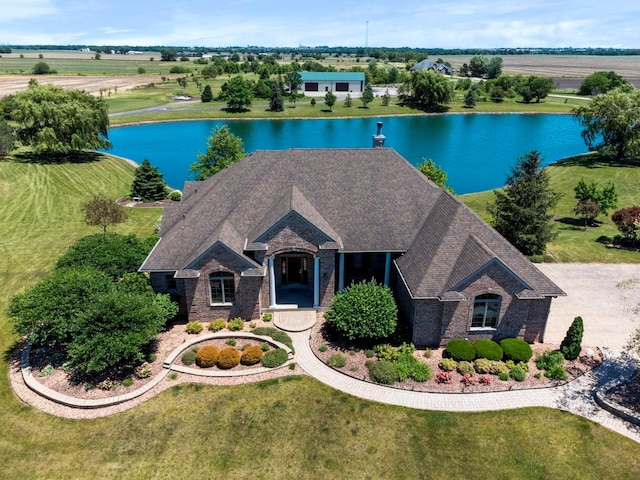 view of front of home with a front yard, a water view, and a rural view