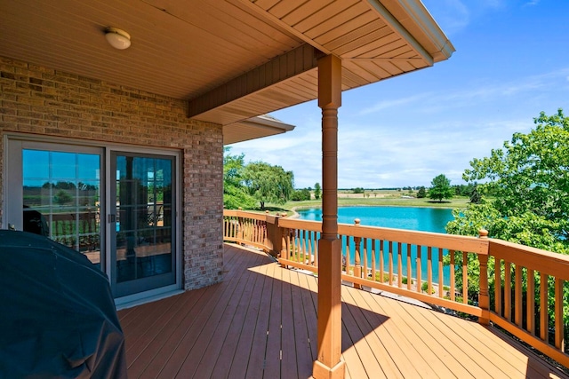 wooden deck featuring a water view and area for grilling