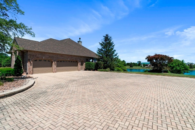 view of side of property featuring a water view and a garage