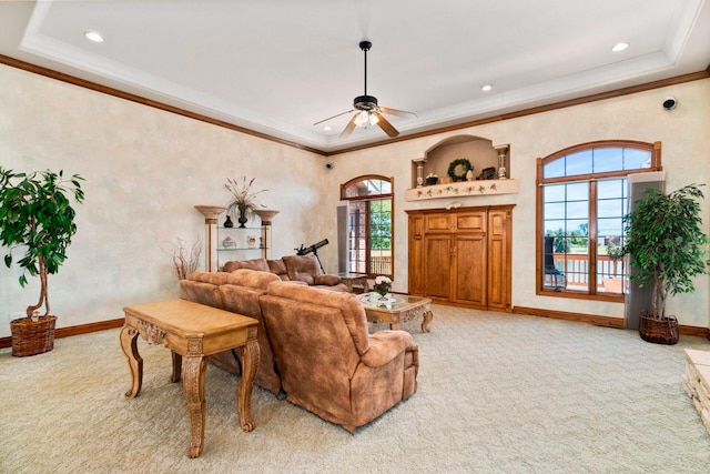 carpeted living room with ceiling fan and crown molding