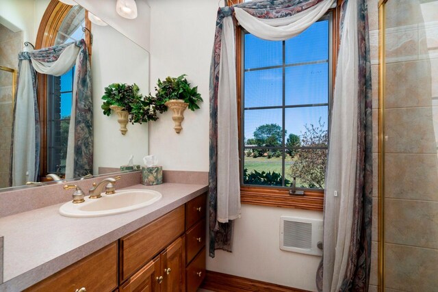 bathroom featuring vanity with extensive cabinet space