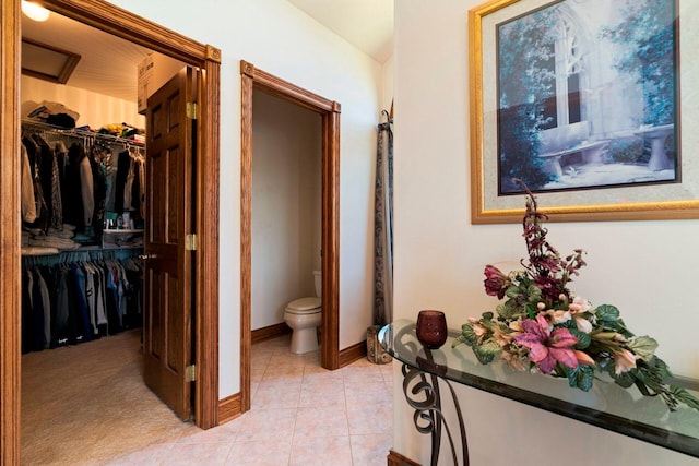 bathroom with tile flooring and toilet