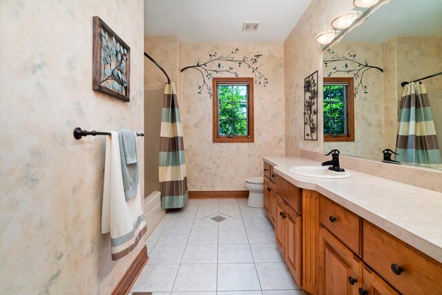 full bathroom with shower / tub combo, tile floors, toilet, and vanity